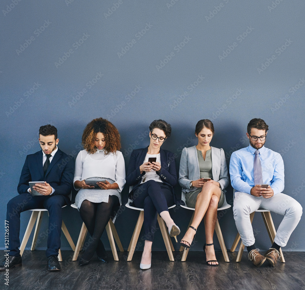 Poster Group of business people at a job interview at a small startup company with copy space. Businesspeople sitting and waiting in line for a meeting with human resources and applying for work