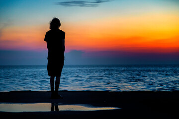 silhouette of a person on the beach at sunset