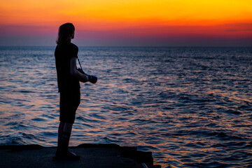 silhouette of a person on the beach at sunset