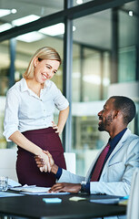 Handshake, greeting and agreement by businesspeople in the office making a deal in partnership. Young happy and diverse coworkers or colleagues in collaboration on a project and handshaking