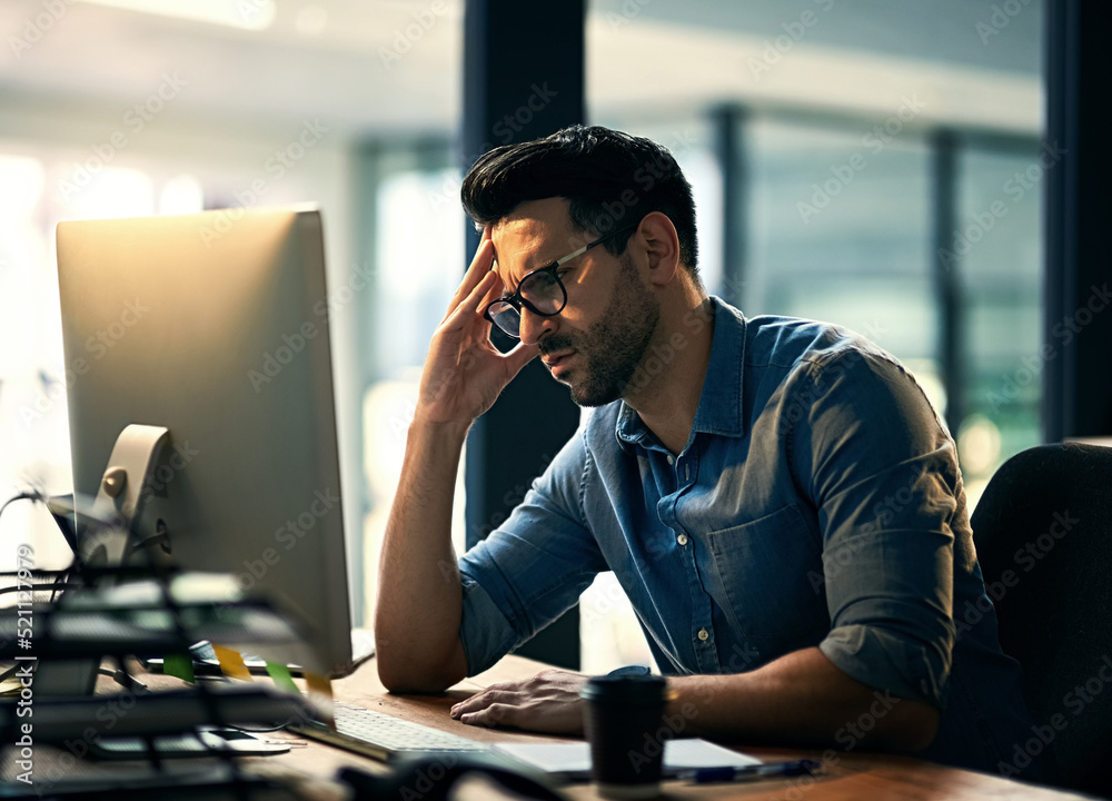 Canvas Prints Is the week over yet. Shot of a young businessman experiencing stress during a late night at work.