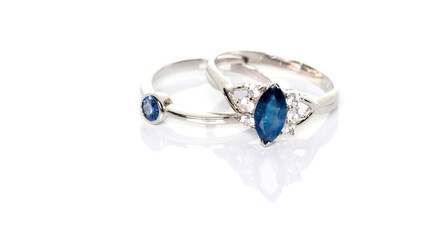 Blue Sapphire with diamonds Jewel or gems ring on white background with reflection. Collection of natural gemstones accessories. Studio shot