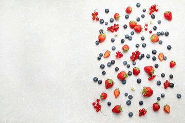 Various fresh berries on neutral background.