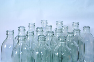 Emty bottles of soda unlabeled set with rows. food and drink industry background. 
