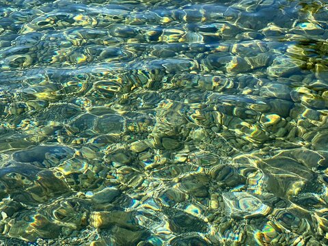 Pebbles stones in transparent sea water. 