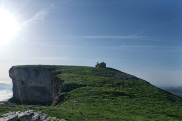 green meadow on the peak of mount beriain, with the hermitage of san donato on the summit. Sierra...
