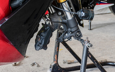 Front view motorcycle up to stand to remove wheel to change tire