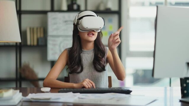 Creative Asian Young female woman wearing smart virtual  glasses and joining business meeting on augmented reality metaverse working space,asia woman using a VR headset to explore virtual space video 