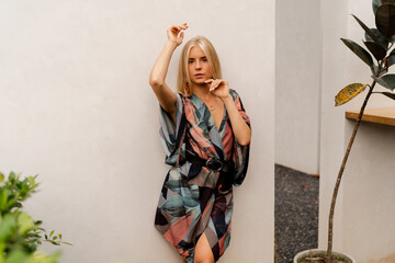Summer fashion photo of elegant blond woman in boho dress posing  light modern interior.