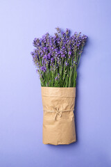 Lavender in craft paper on violet background