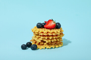 Concept of tasty food with wafers on blue background