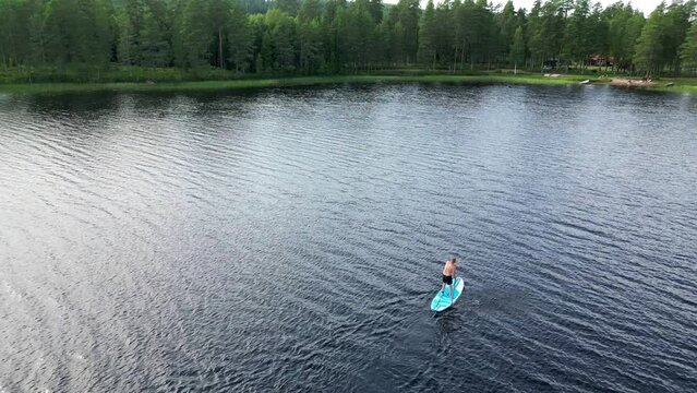 Fast Fly Over Active Person Stand Up Paddle Boarding On Serene Lake In Dalarna, Sweden. Aerial Drone Shot