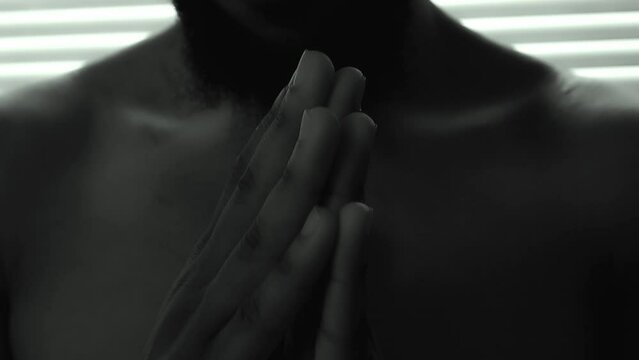 Afro Black Man praying and believe in a new religion. extreme close shot