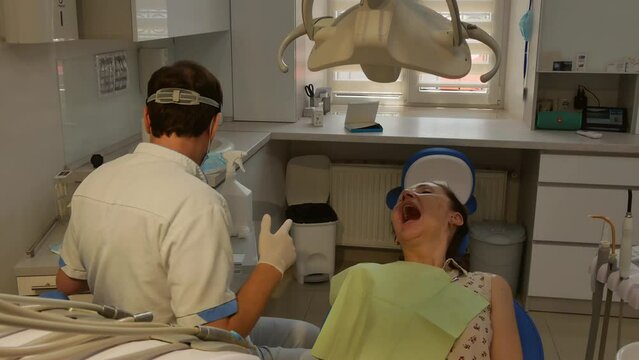 Dental clinic. Young adult woman at the dentist appointment.