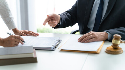 Lawyer Legal counsel presents to the client a signed contract with gavel and legal law. justice and lawyer Business partnership meeting concept.