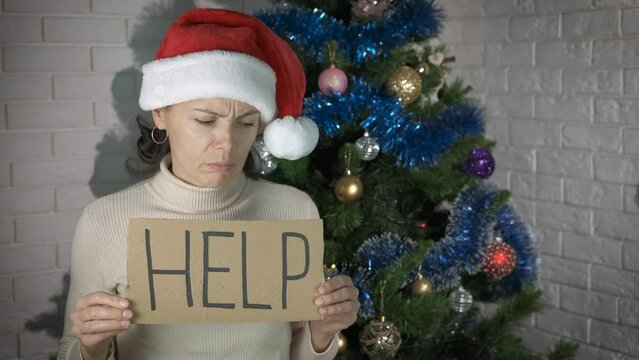 Woman in need for Christmas holiday. A woman in Santa hat in need ask for help in the Christmas room.
