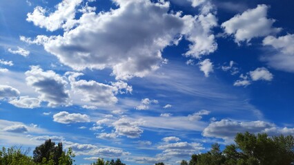 Beautiful white clouds on a blue sky, sunny summer day.