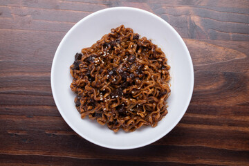 Jajangmyeon or JJajangmyeon instant noodles black bean sauce Korean food style in a white cup.