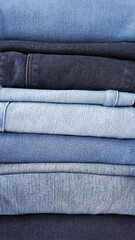 Stack of various shades of neatly folded vintage denim jeans