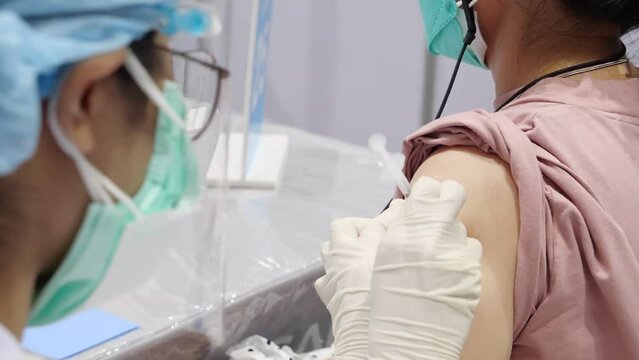 Asian Medical Staff Give Vaccination Shot, Close Up