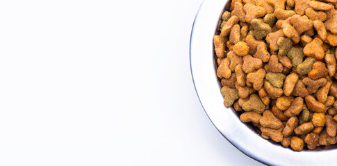 A close-up of part of a metal bowl with dry food for animals, cats and dogs