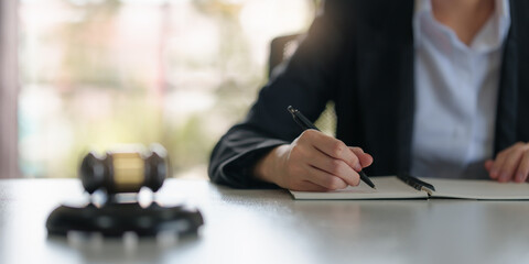 Lawyer business woman reading law book and agreement contract