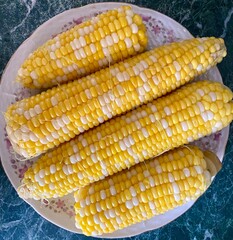 many corns on the plate close up, tasty vegan food, delicious simple food, ugly vegetables
