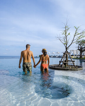couple man and woman on a luxury vacation enjoying the infinity pool on the rooftop, Pattaya Thailand. sunny day in Pattaya