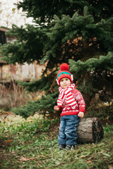 Child waiting for Christmas in wood. portrait of little boy near christmas tree. Baby decorating pine. winter holidays and people concept. Merry Christmas and Happy Holidays.