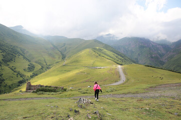 Fototapeta premium Toddler climbs a high mountain
