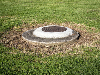 Pipeline manhole with iron cover lid.