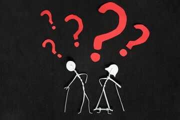 Senior or old people dementia problem, memory loss and Alzheimer's disease concept.  Elderly couple stick figure with red question mark in dark black background creative composition.