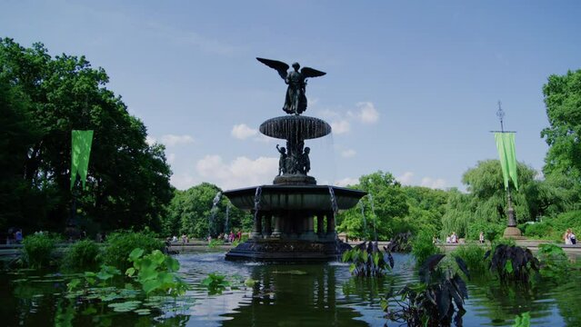 Fountain with Angel of the Waters statue. Bethesda Terrace. Lake in New York City's Central Park. USA. Summer, daytime. High quality 4k footage