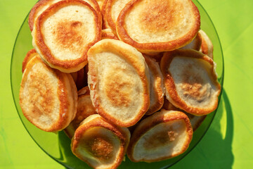 Roasted Pancakes on the plate on green background