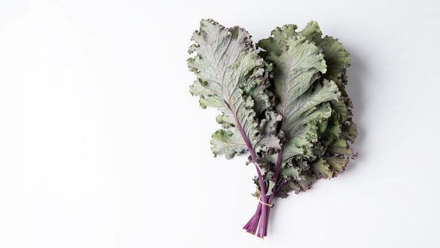 Bunch of fresh red kale over a white background