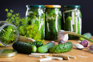 Homemade pickling cucumbers in a jar. Necessary ingredients for pickling, such as dill, garlic, salt and horseradish. Selective focus.