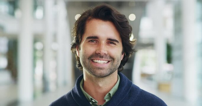 Happy, nerd and smart face business man smiling after a great day at work and standing in a corridor or office building. Portrait of a satisfied caucasian male entrepreneur with a bright smile