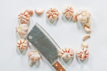 Garlic,knife  a wooden cutting board in the kitchen, selective focus