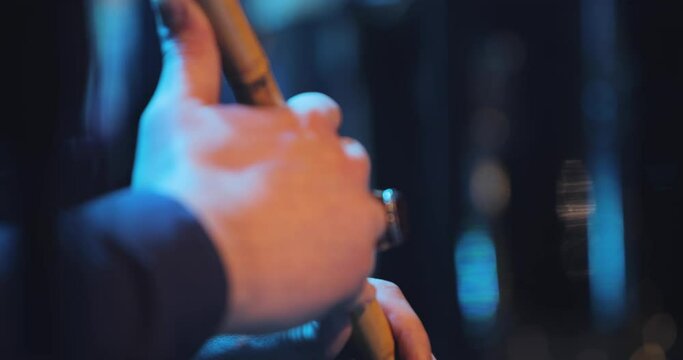 A slightly moving shot of a musician playing on his ney-the sufi music instrument-the shot is moving up