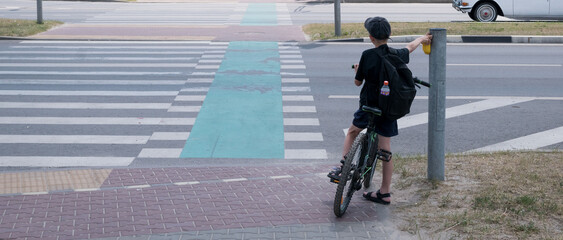 A little boy rides around the city on a bicycle