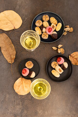 Obraz na płótnie Canvas Different panellet and glass on sweet wine on cocnrete table. Typical confection for All Saints Day in Catalonia,Spain.