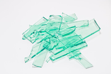 Abstract broken green glass in motion into pieces isolated on white background.