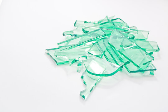 Abstract broken green glass in motion into pieces isolated on white background.