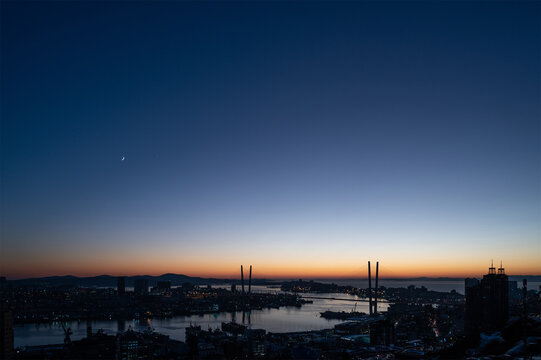 Crescent moon and venus in the dark evening sky.