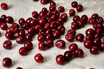 red ripe cherries scattered on the table