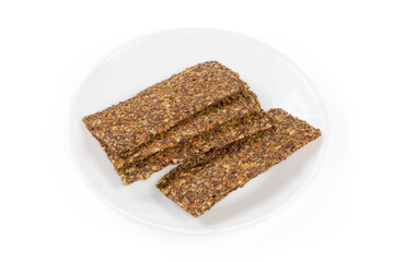 Flat crispbreads with vegetables, mushrooms and seeds on a saucer