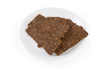 Flat crispbreads with vegetables and seeds on a saucer