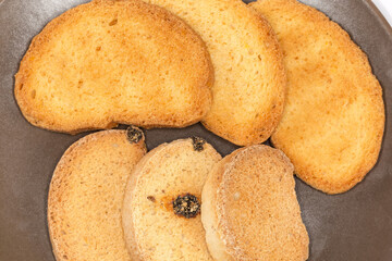 Two types of rusks on dish, top view close-up