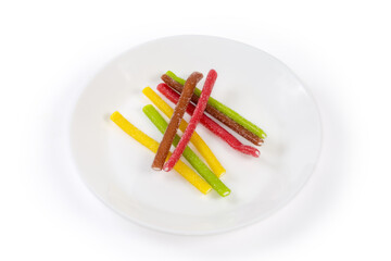 Multicolored jelly stick candies on a white dish