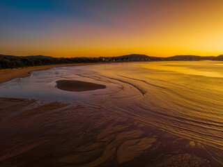 Aerial sunrise seascape with orange glow on a cold Winter's morning